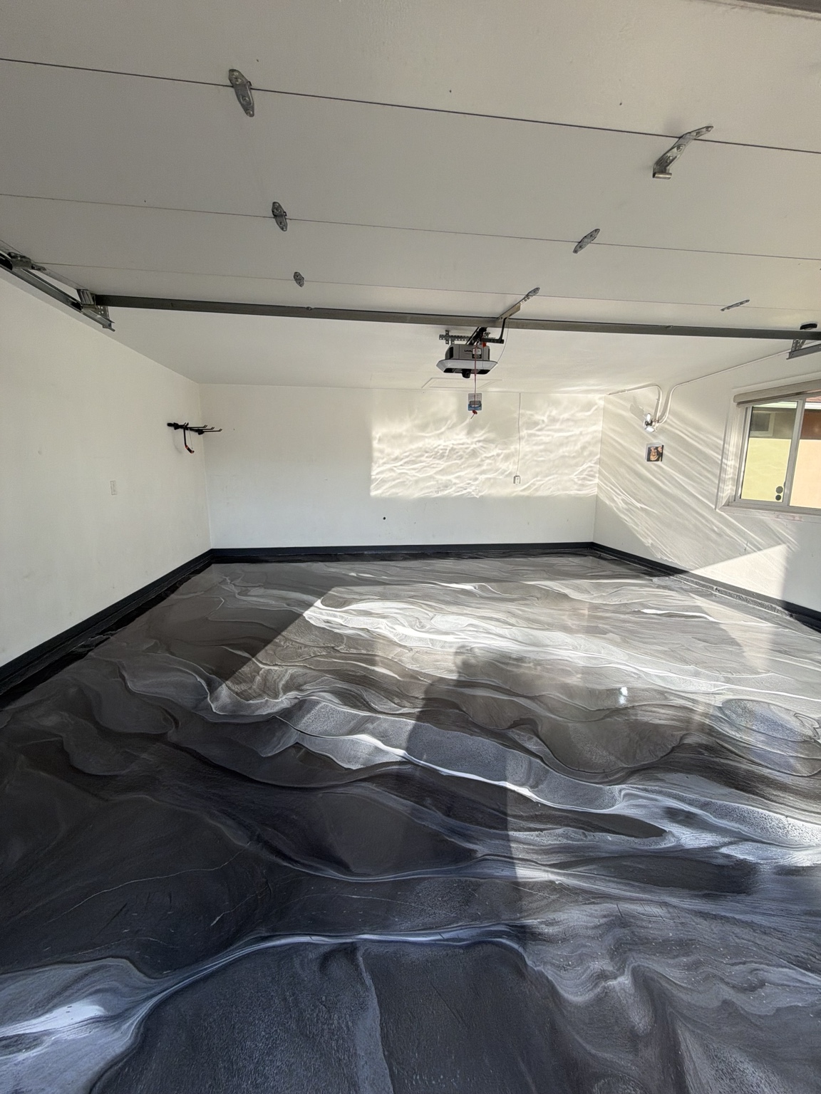 Black and silver metallic epoxy garage floor